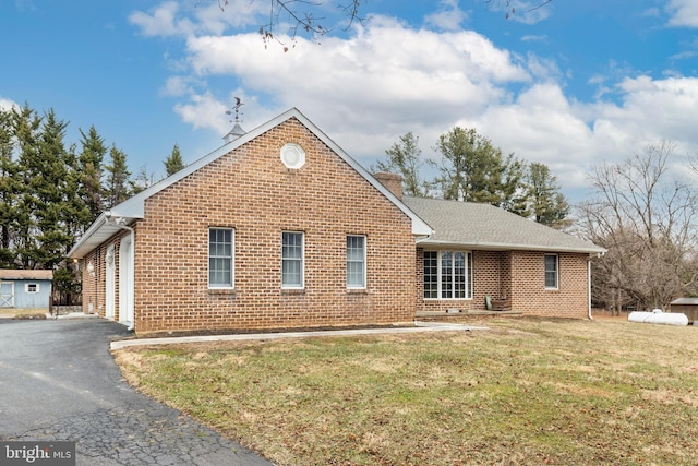 view of side of property featuring a yard