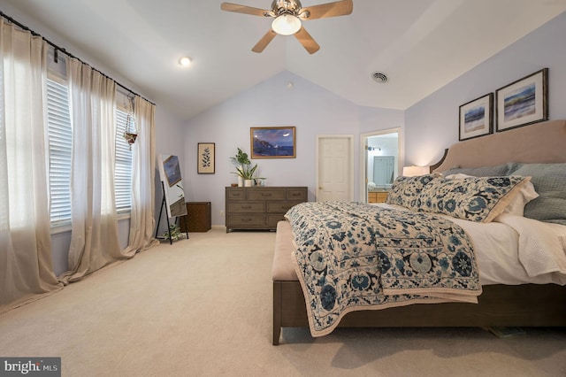 carpeted bedroom with ceiling fan, connected bathroom, and lofted ceiling