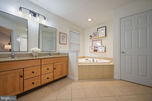 bathroom featuring vanity, tiled tub, and tile patterned floors