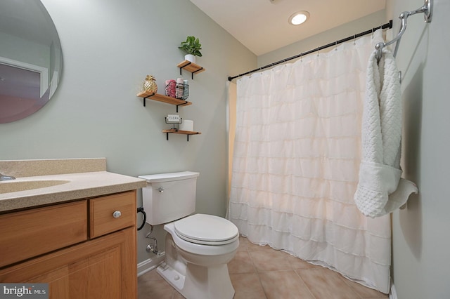 bathroom featuring walk in shower, vanity, tile patterned floors, and toilet