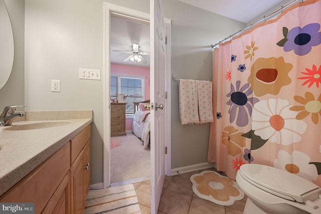 bathroom with toilet, vanity, tile patterned floors, and ceiling fan