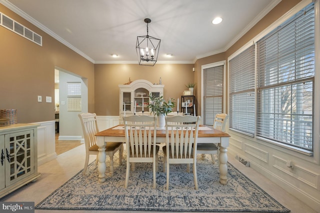 dining room with a notable chandelier and crown molding