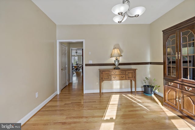 dining room featuring light wood-type flooring and baseboards