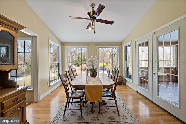 sunroom / solarium with lofted ceiling, french doors, and ceiling fan