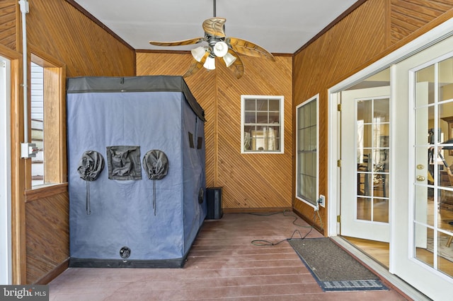 unfurnished sunroom featuring ceiling fan and plenty of natural light