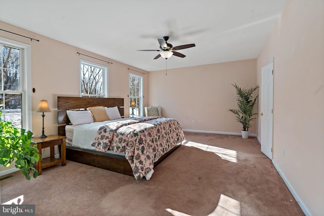 carpeted bedroom featuring a ceiling fan and baseboards