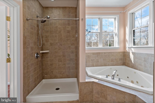 full bathroom with a stall shower and a tub with jets