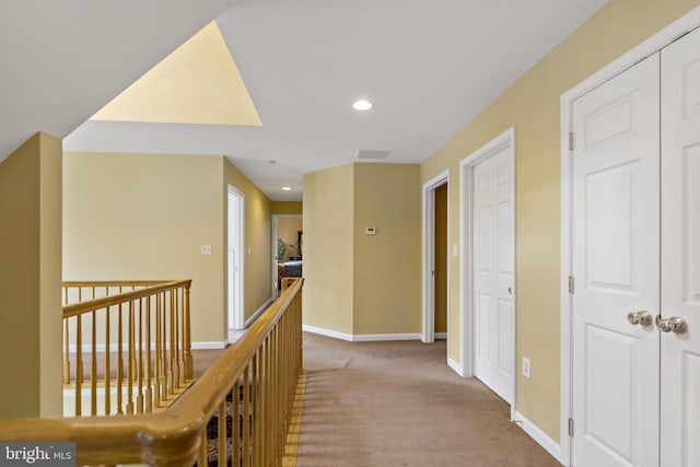 hallway featuring visible vents, baseboards, carpet flooring, and recessed lighting