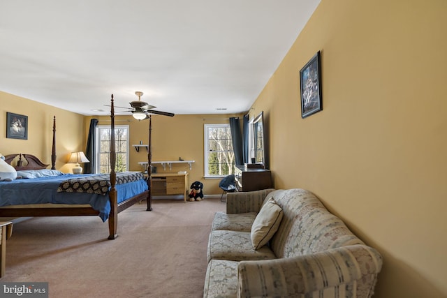 bedroom with baseboards, a ceiling fan, and light colored carpet