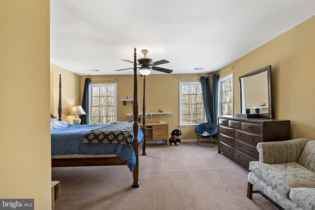 carpeted bedroom with a ceiling fan, visible vents, and baseboards