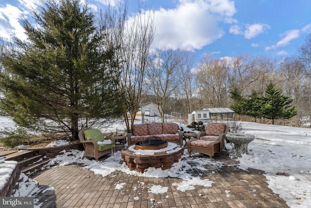 snow covered deck with a fire pit