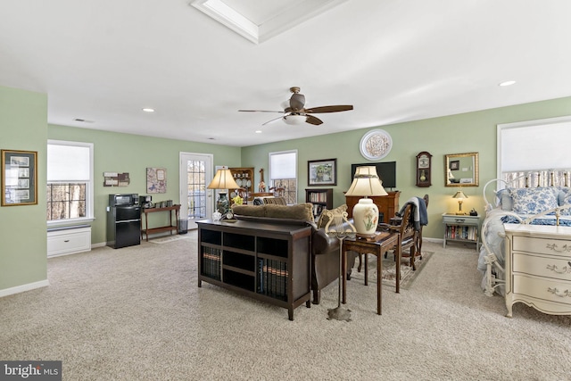 carpeted living room featuring a ceiling fan, recessed lighting, and baseboards