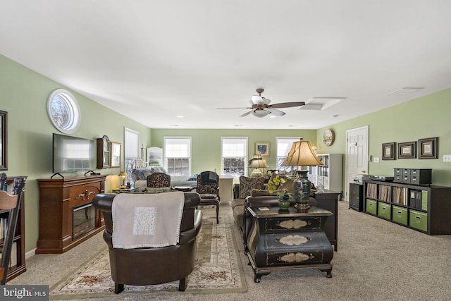 carpeted living area featuring ceiling fan