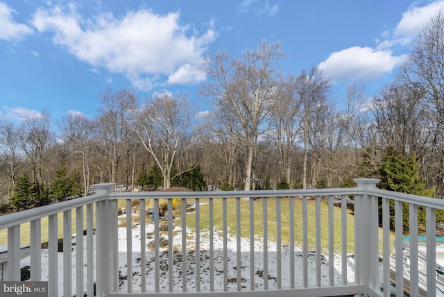 wooden deck featuring a yard