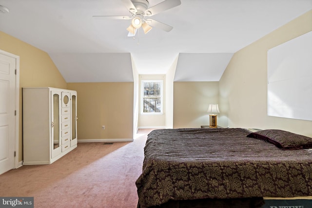 bedroom featuring a ceiling fan, baseboards, vaulted ceiling, and carpet flooring