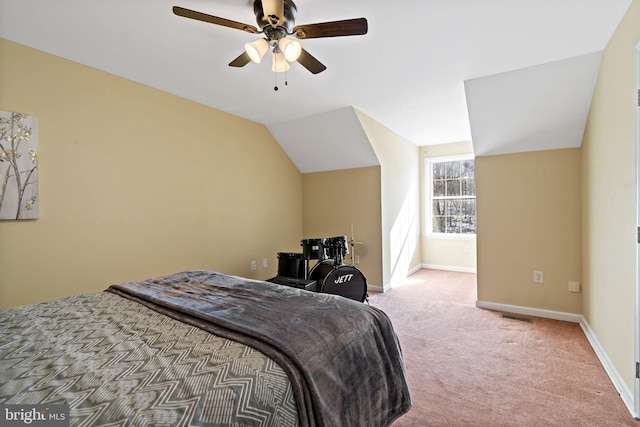 carpeted bedroom with ceiling fan, baseboards, visible vents, and vaulted ceiling