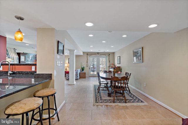 dining room featuring baseboards, french doors, decorative columns, and recessed lighting