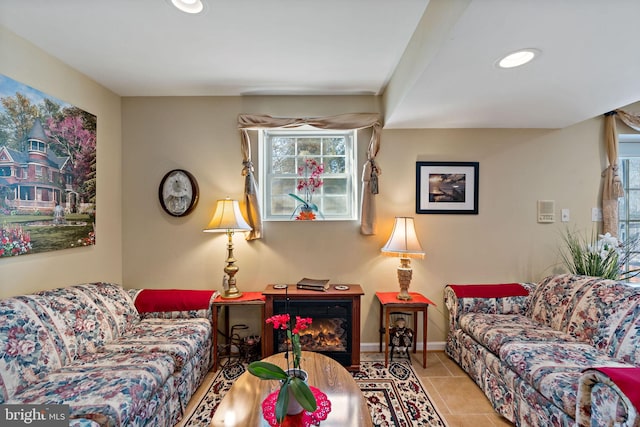 tiled living area featuring a warm lit fireplace, recessed lighting, and baseboards