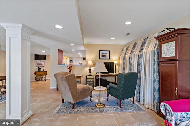 sitting room with light tile patterned floors, recessed lighting, visible vents, baseboards, and ornate columns