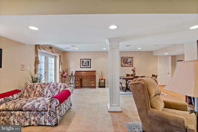 living room with ornate columns, light tile patterned flooring, and recessed lighting