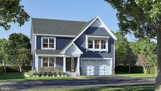 view of front of home with a front yard and a garage