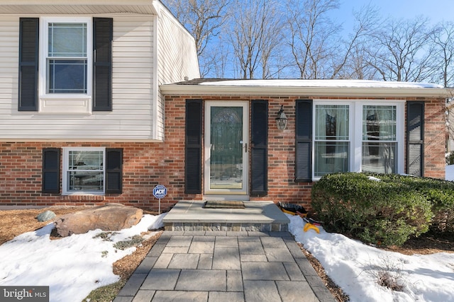 view of snow covered property entrance