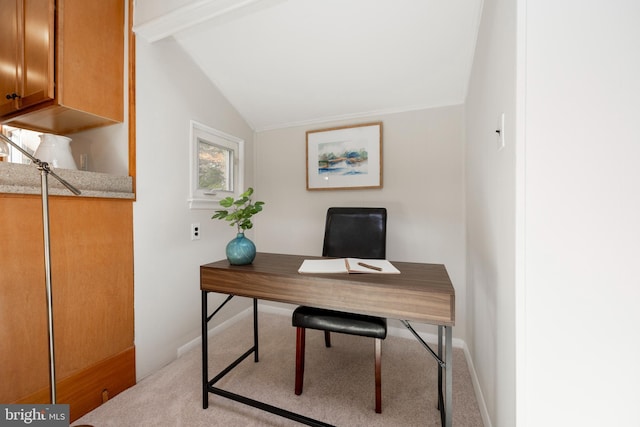 carpeted home office featuring vaulted ceiling