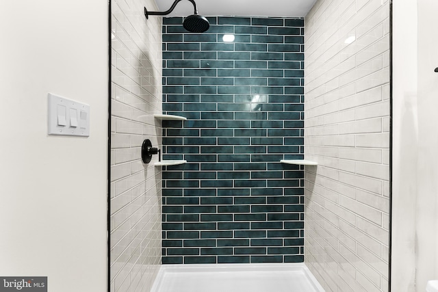 bathroom with a tile shower