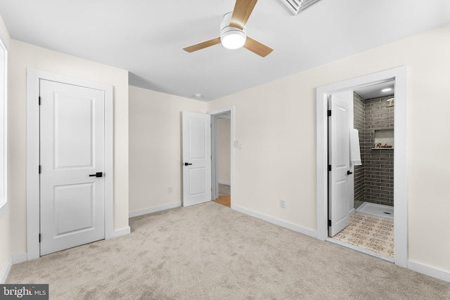 unfurnished bedroom featuring connected bathroom, light colored carpet, and ceiling fan