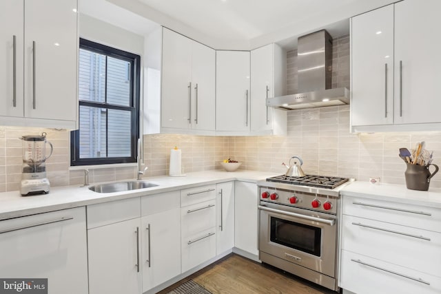 kitchen featuring backsplash, wall chimney exhaust hood, luxury range, and white cabinetry