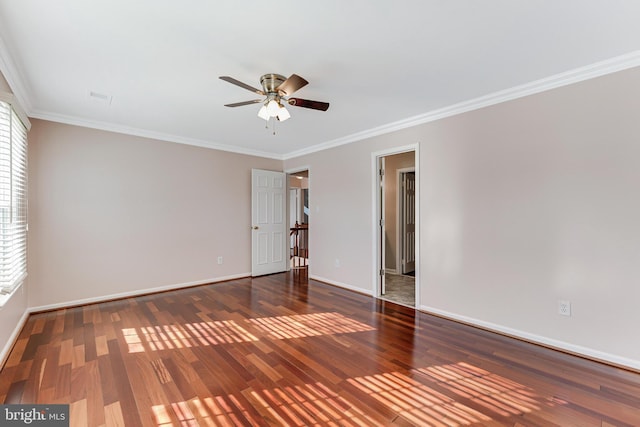 empty room with crown molding, ceiling fan, plenty of natural light, and dark wood-type flooring