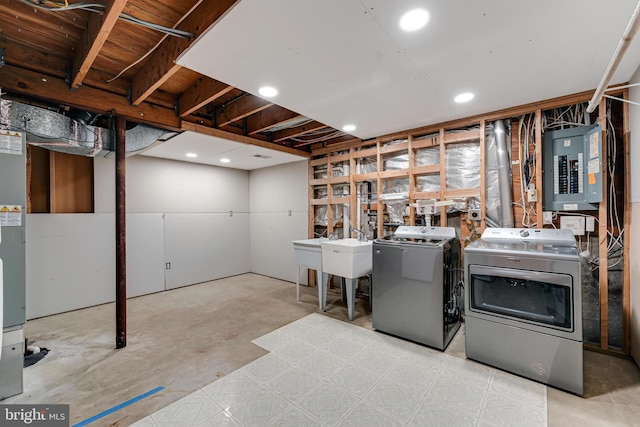 washroom with separate washer and dryer, sink, and electric panel