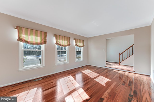 unfurnished room with hardwood / wood-style floors