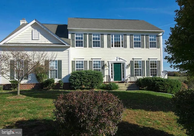 colonial home with a front yard