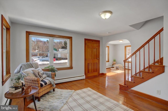 entryway featuring a baseboard radiator and light hardwood / wood-style flooring