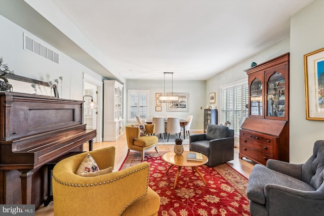 living room with light hardwood / wood-style flooring and a wealth of natural light