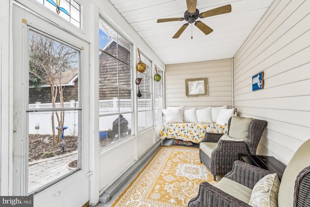 sunroom / solarium featuring ceiling fan