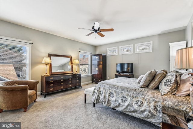 bedroom featuring light colored carpet and ceiling fan