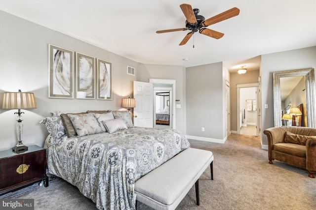 bedroom with ensuite bathroom, ceiling fan, and carpet