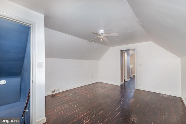 additional living space featuring dark wood-type flooring, lofted ceiling, and ceiling fan