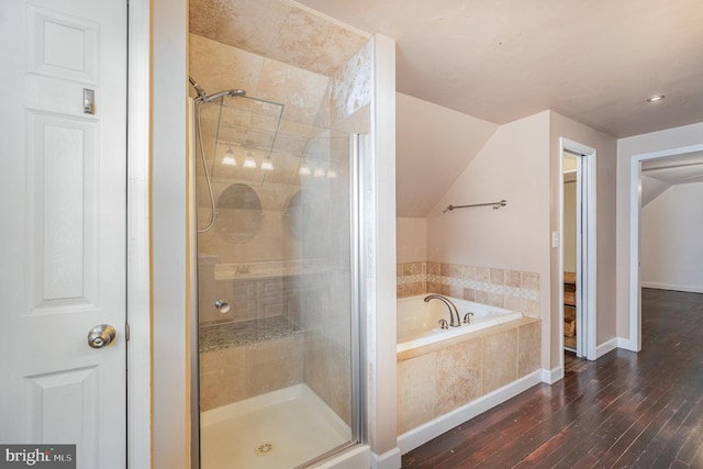 bathroom featuring vaulted ceiling, shower with separate bathtub, and hardwood / wood-style floors