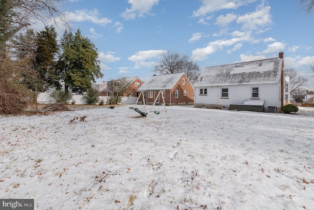 view of snow covered back of property