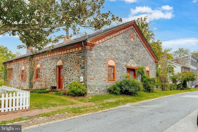 view of side of property with a yard