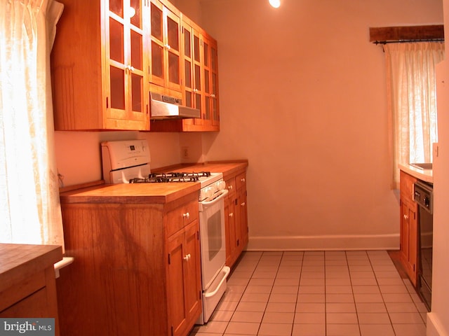 kitchen with light tile patterned floors, gas range gas stove, and dishwasher