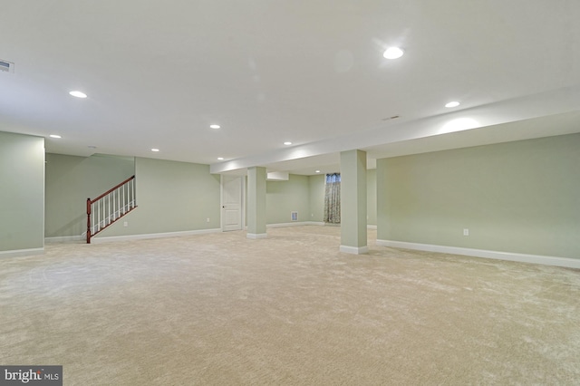 basement featuring light colored carpet