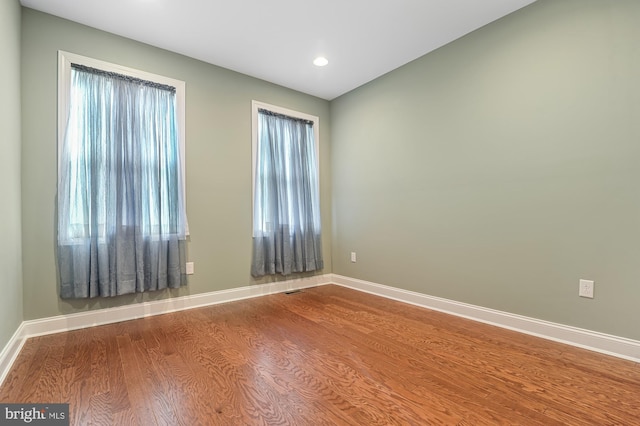 spare room with wood-type flooring