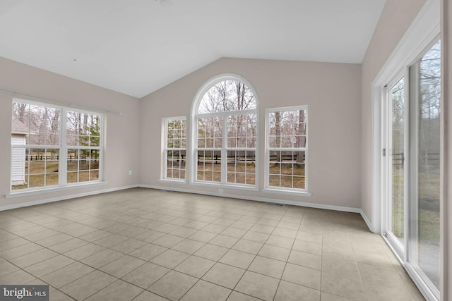 unfurnished sunroom featuring a healthy amount of sunlight, vaulted ceiling, and visible vents