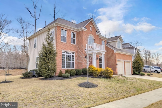 view of front facade with brick siding, driveway, a balcony, and a front lawn