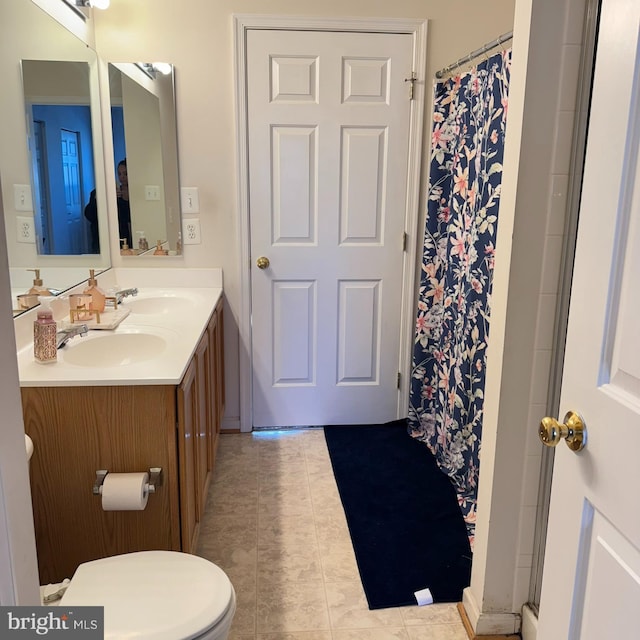 bathroom featuring toilet, tile patterned floors, a shower with shower curtain, and vanity