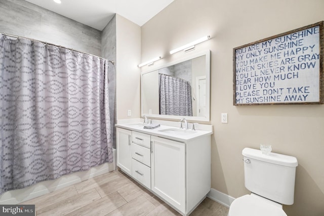 full bathroom with toilet, vanity, and shower / tub combo with curtain